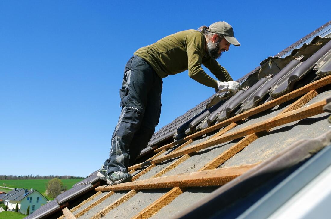 man installing a roof shingles